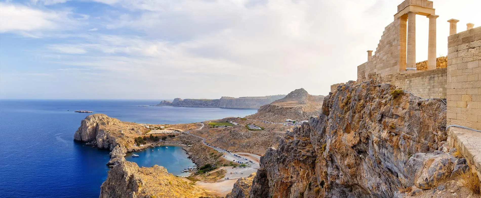 Lindos acropolis on Rhodes island with sea views and ancient ruins on a sunny day.