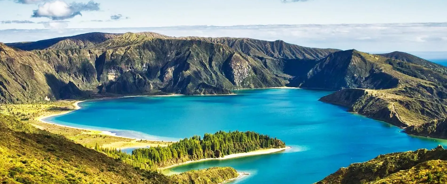 Lagoa do Fogo crater lake surrounded by mountains and forest on Sao Miguel Island, Portugal.