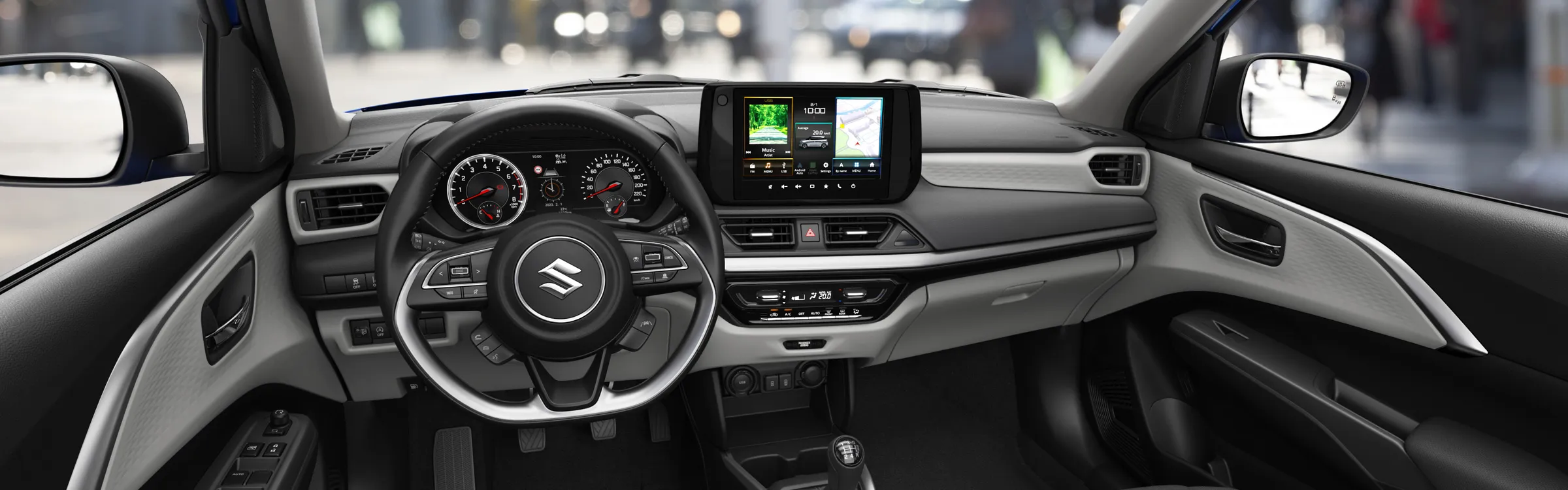 Suzuki car rental interior showing steering wheel, dashboard, touchscreen, and manual gear shift.