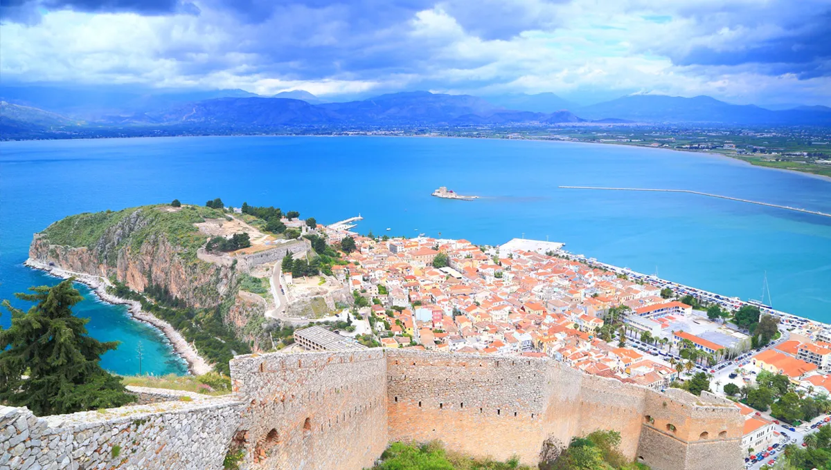 Nafplio town and bay coastline with historic fortress walls and mountain views in Greece.