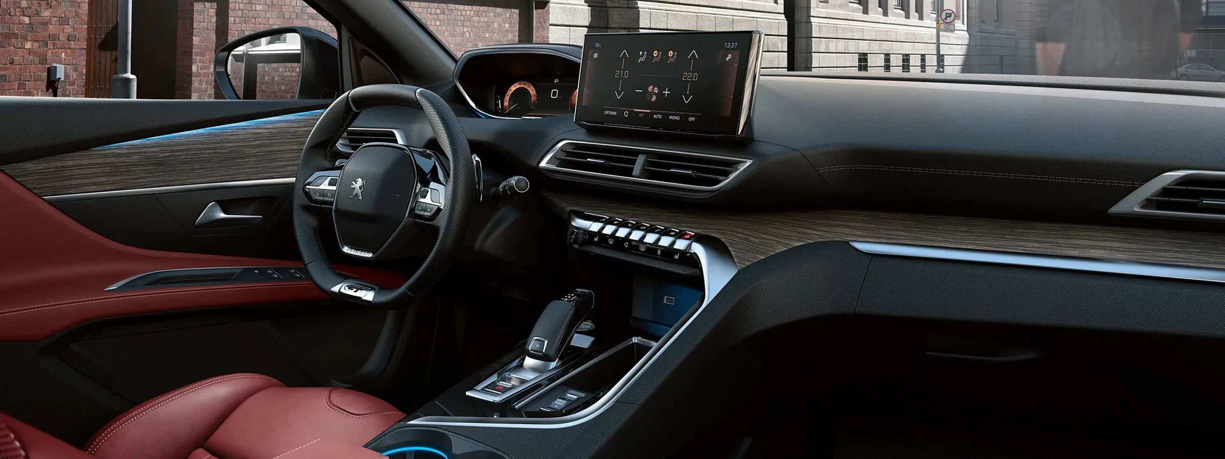 Peugeot car rental interior with modern dashboard, touchscreen, and red leather seats.