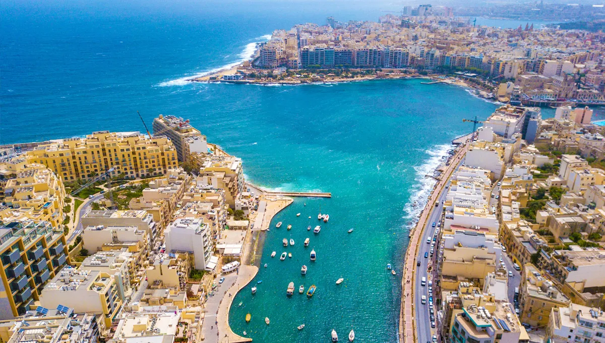 Aerial view of St. Julian's coastline and bay with boats in the water for car rental travelers.