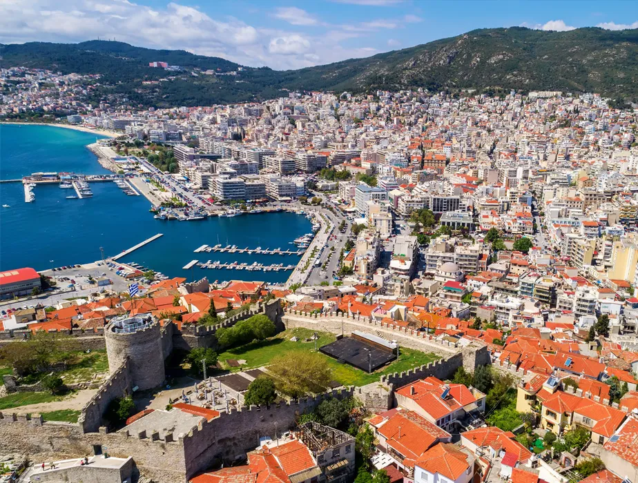 Kavala town and bay in Greece with historic fortress walls and densely built urban area.