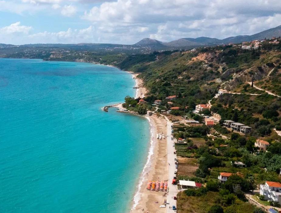 Beautiful coastline with turquoise waters and a sandy beach in a Mediterranean rental car destination.