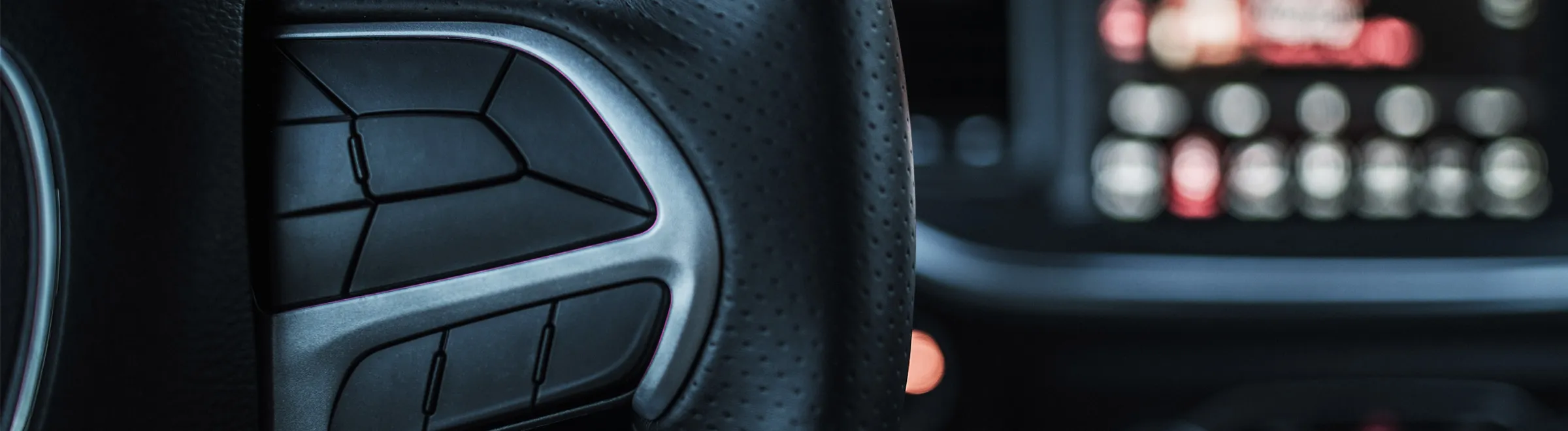 Close-up of car steering wheel controls in a rental car for easy driving and safety features.